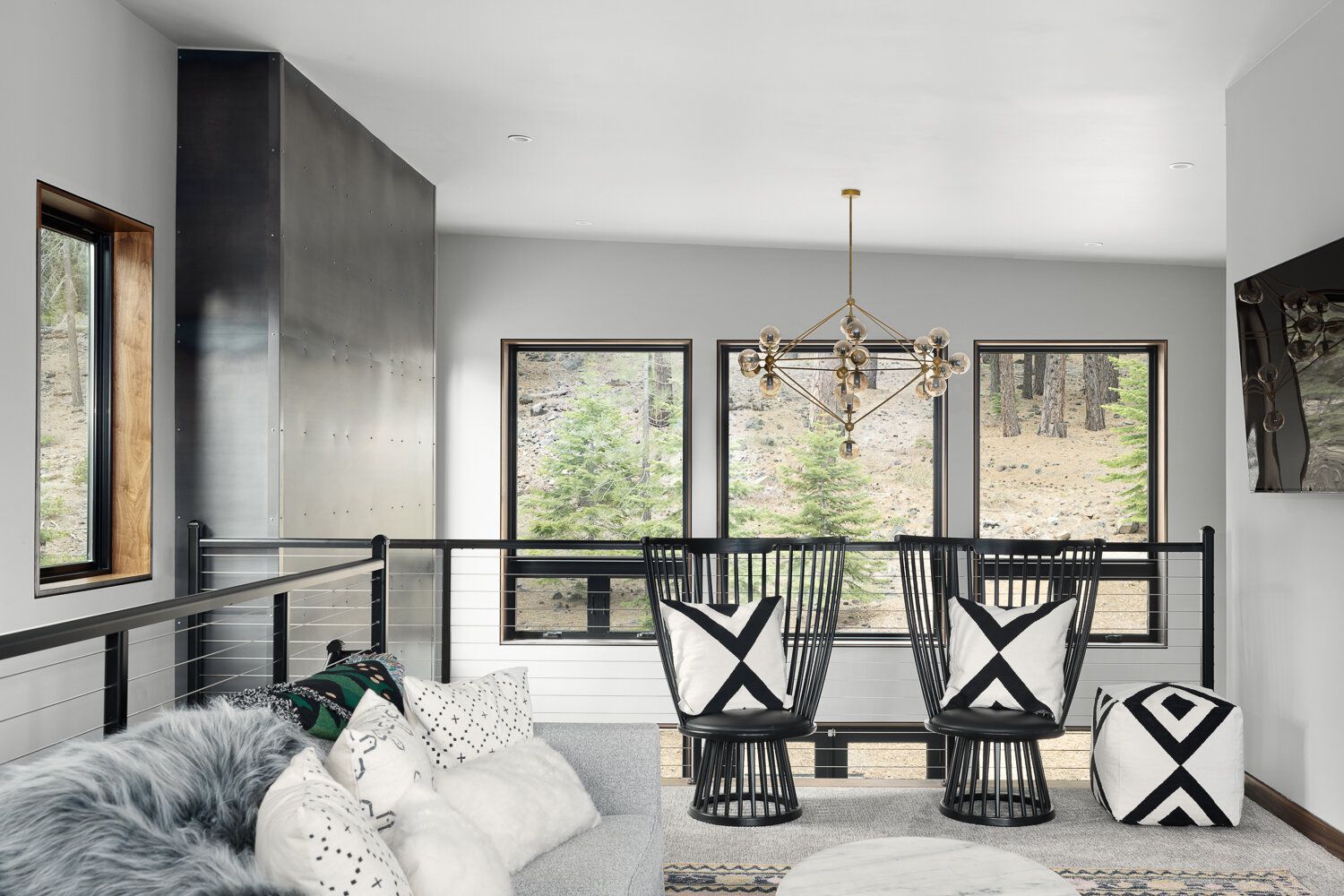 Modern living room with large scenic windows and forest view in Auburn, CA replacement windows and doors