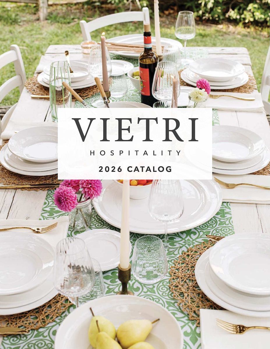 Vietri 2026 catalog cover image with a table set up outside with plates, bowls and glasses from their collection.