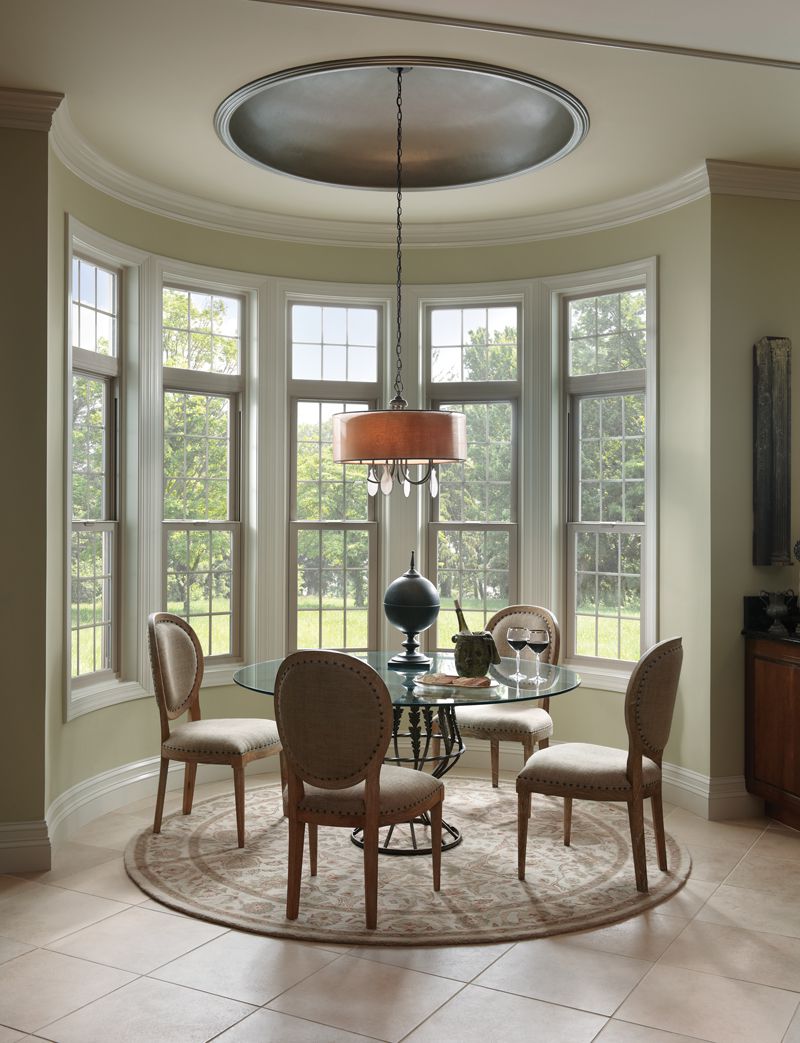 Curved breakfast nook with Milgard Tuscany V400 windows with backyard views