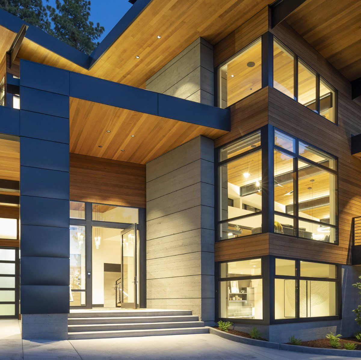 All glass pivot door entry at modern residential project by California Craftsman