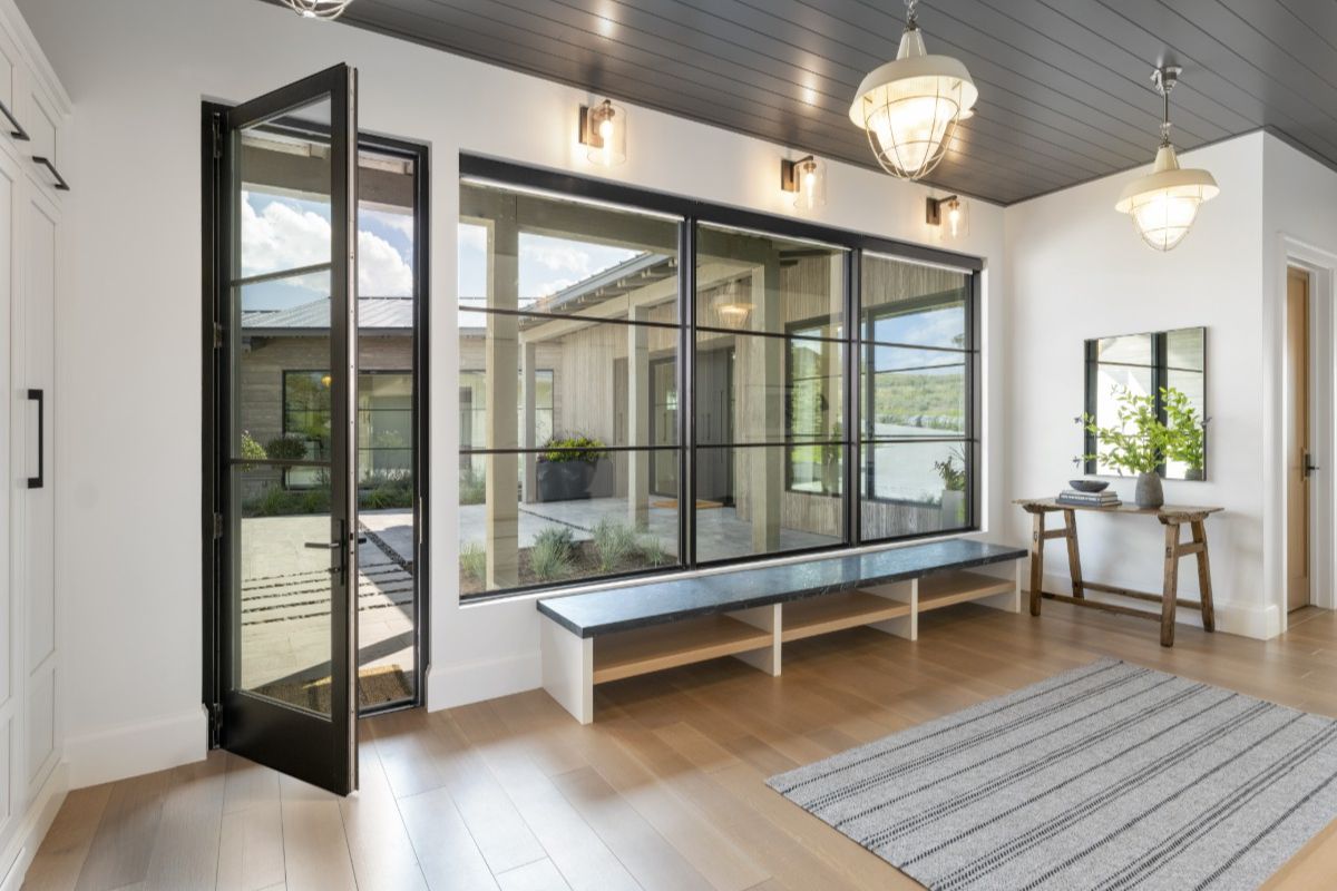 Western Architectural Openings hinged glass door integrated with Performance series fixed window system