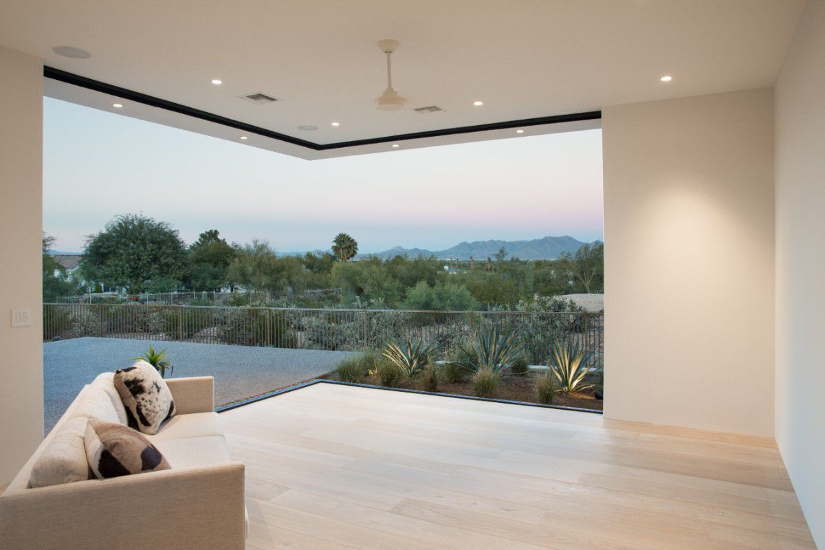 Western Architectural Openings moving glass wall with large sliding glass panels opening to an outdoor living area