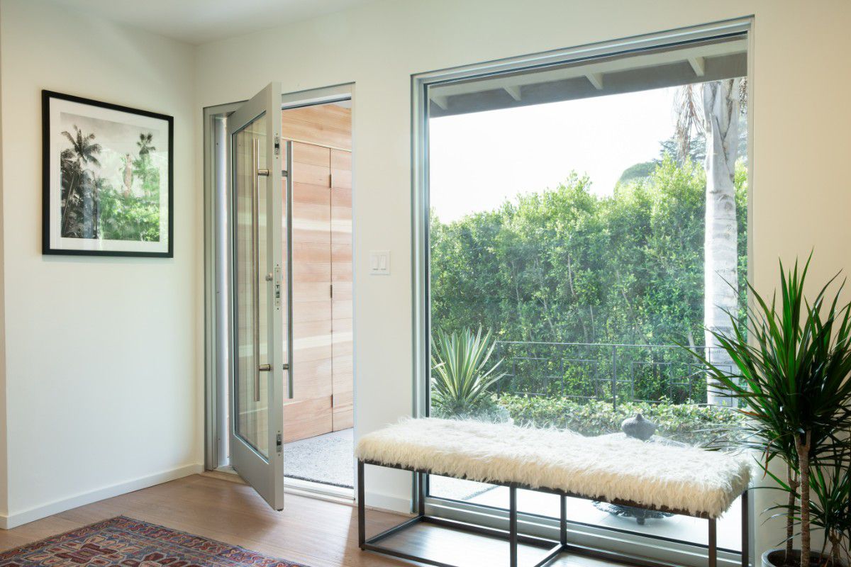 Western Architectural Openings pivot door creating a dramatic modern entryway