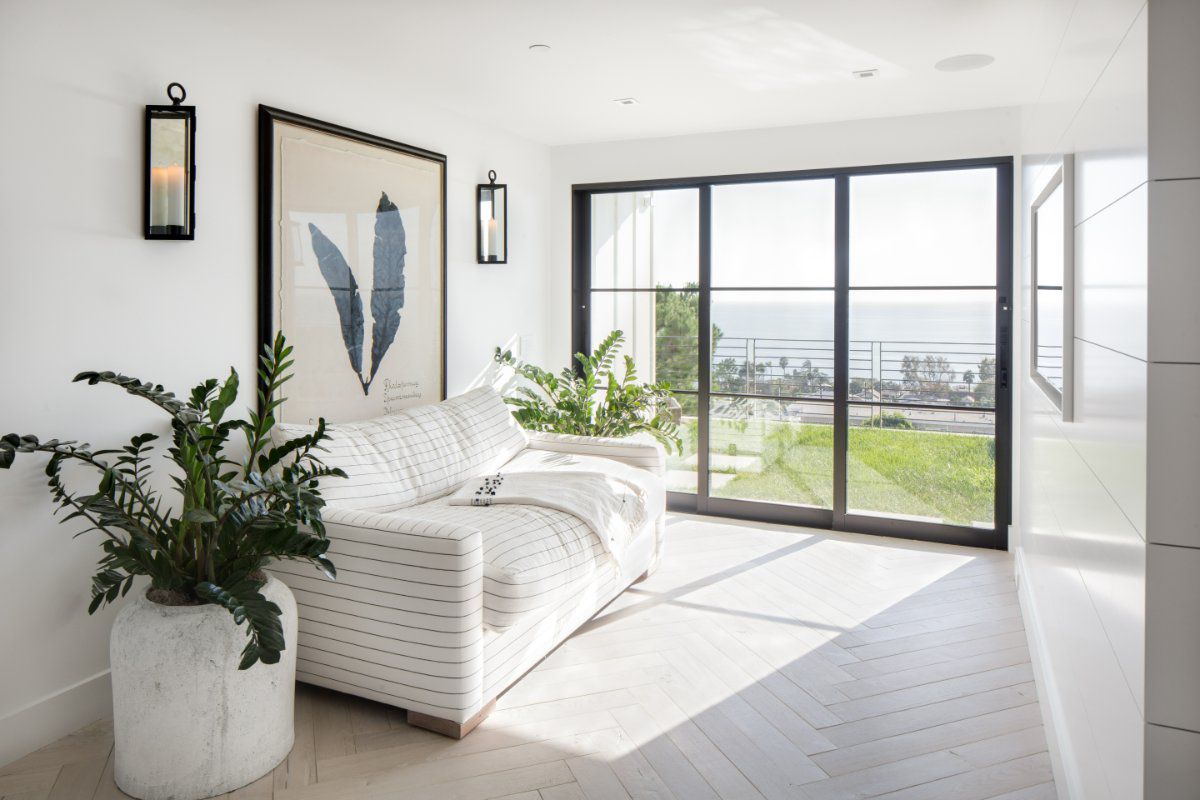 Multislide Euroline patio doors connect a bright contemporary room with backyard views