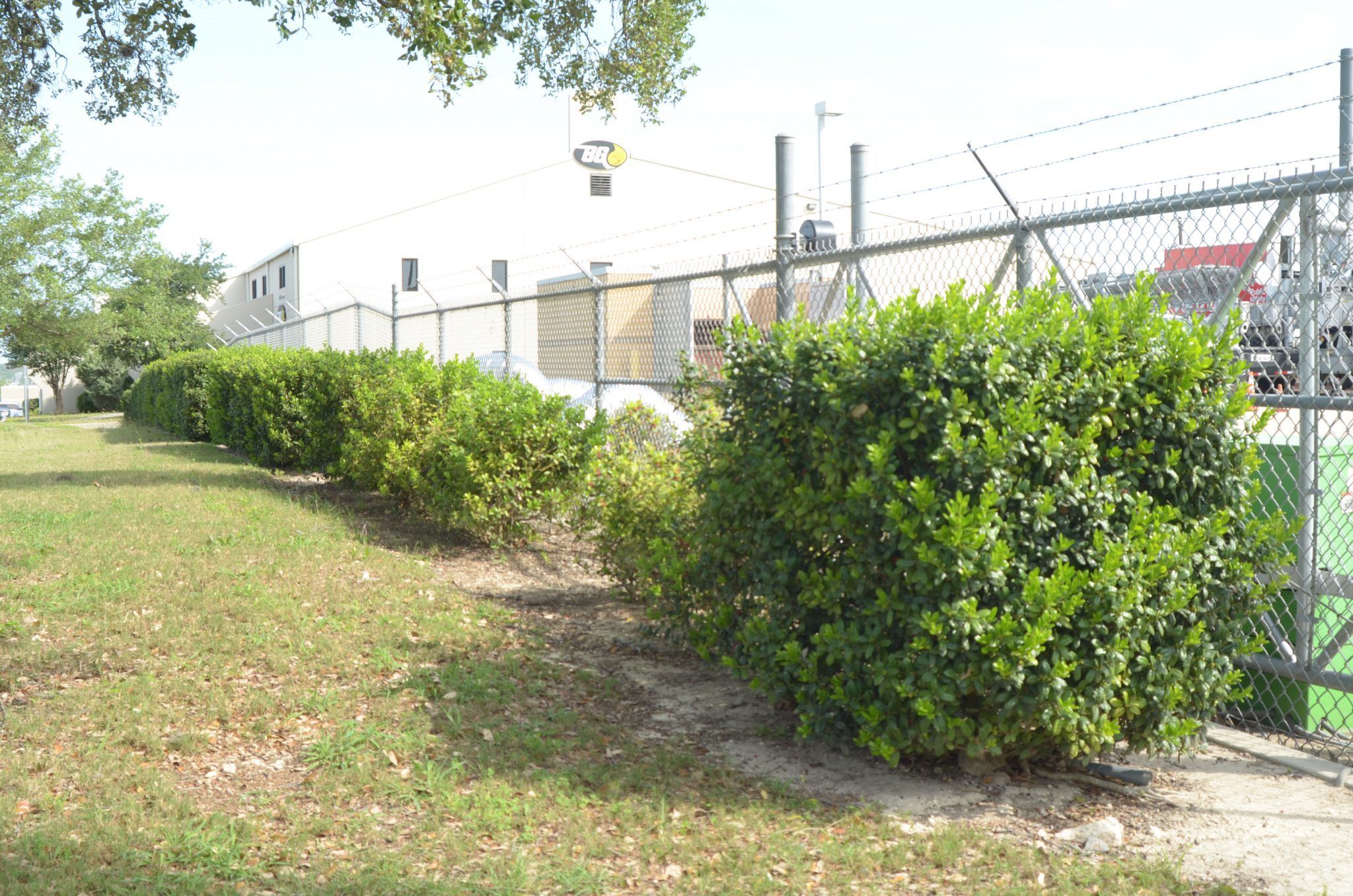 <img src="commercial-fence.jpg" alt="Heavy-duty chain-link fencing installed for commercial property security in San Antonio.">