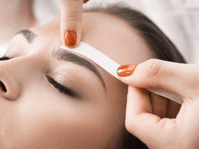 Eyebrow getting waxed