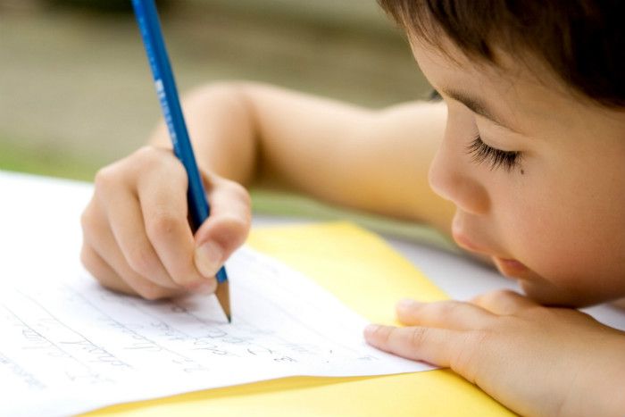 Child writing on paper