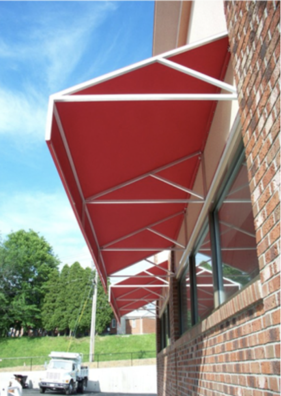 This close-up view of a flat red awning highlights the tight fabric tension and durable framework of Mineola Signs' installations. Ideal for high-traffic storefronts, this awning combines function and style with long-term reliability.