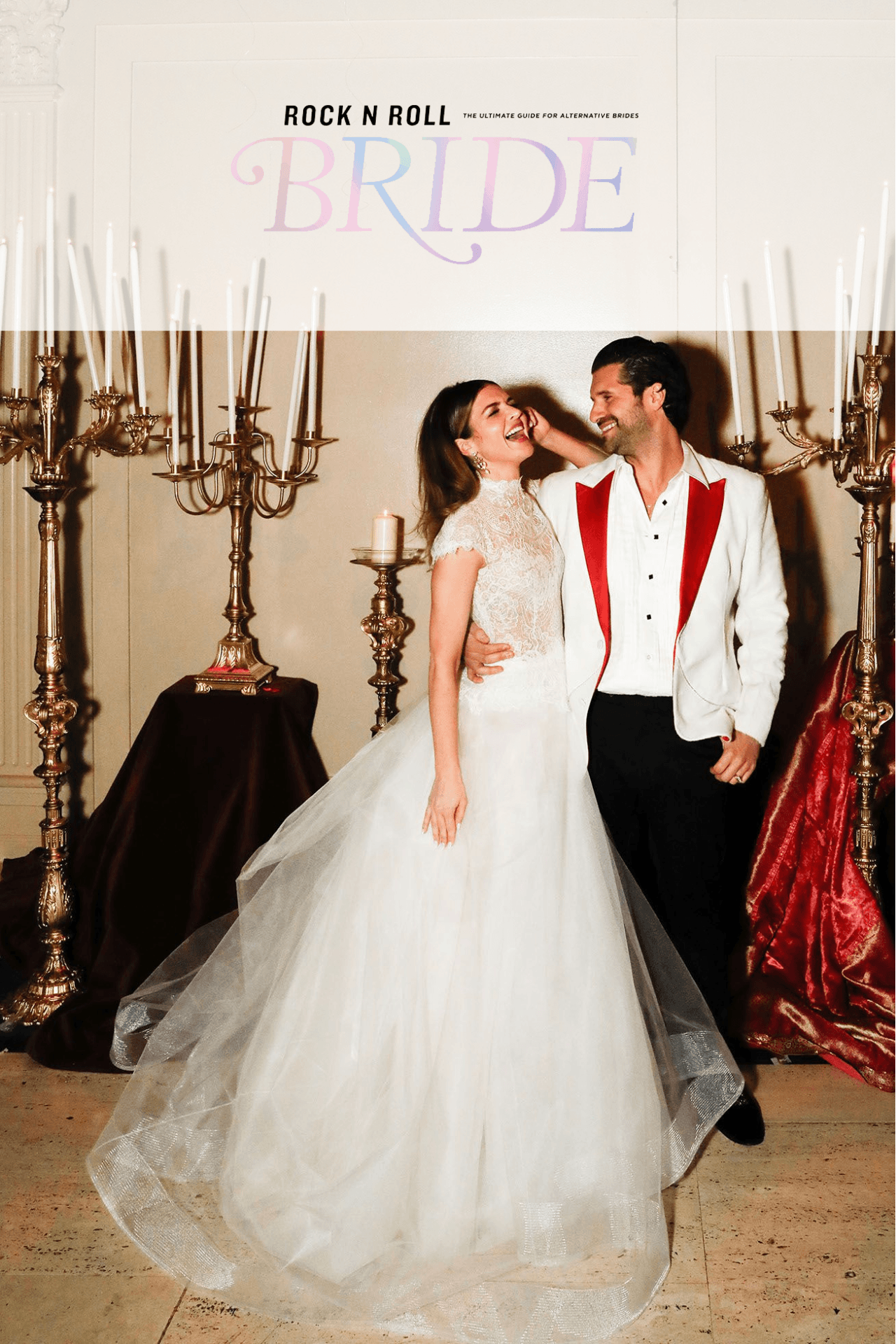 Married couple in a wedding setting with large candle holders with candles in the background.