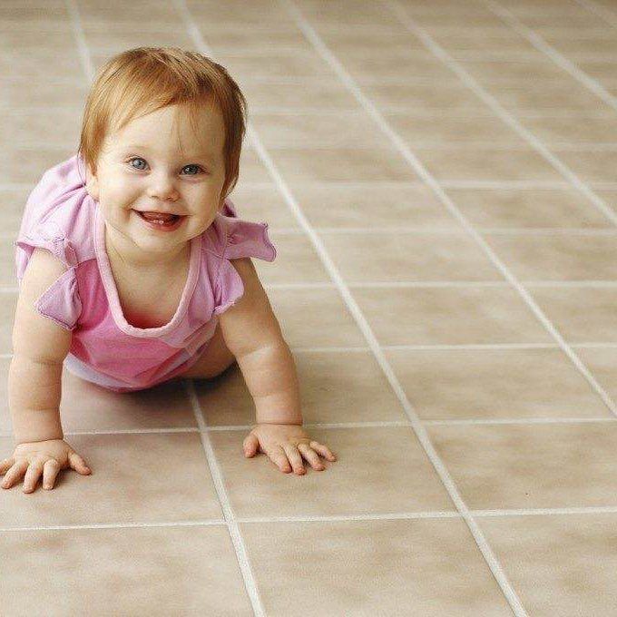 female toddle crawling on the tiles