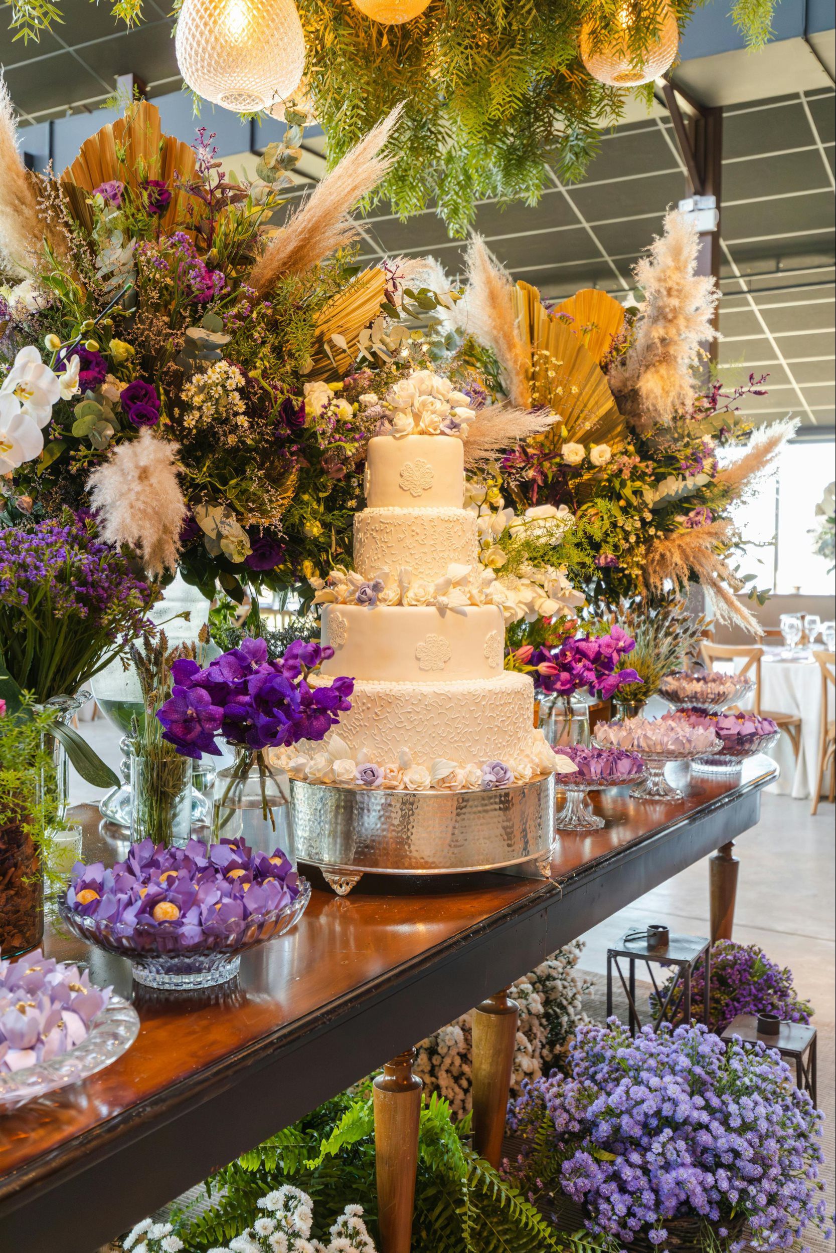 Romantic spring wedding cake surrounded by lush pastel florals and Valentine’s-inspired décor for a springtime celebration