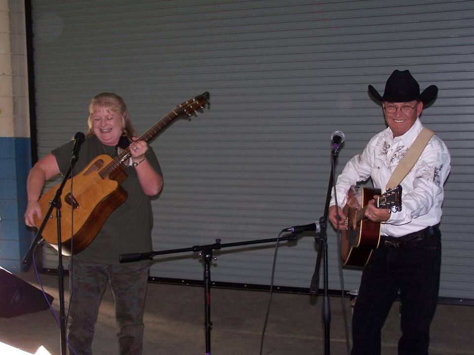 two men on stage with their guitar
