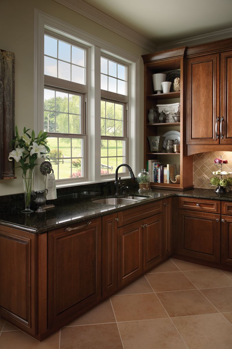 Milgard V400 Tuscany Series vinyl windows provide additional natural light and ventilation in this kitchen.