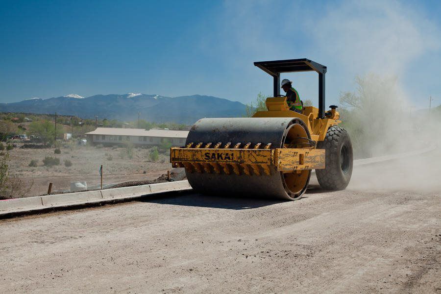 Road roller compacting gravel surface