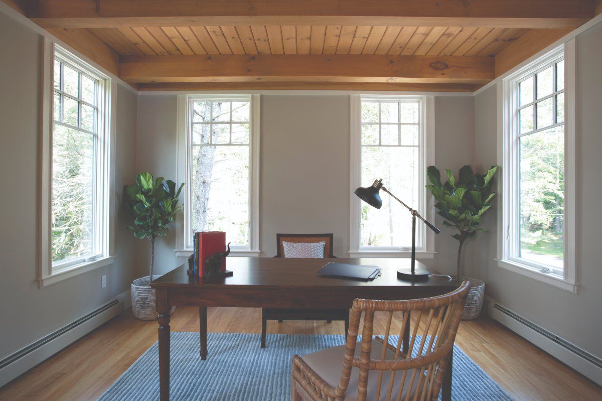Weather Shield Signature Series aluminum-clad wood casement windows bring natural light and outdoor views into a home office.