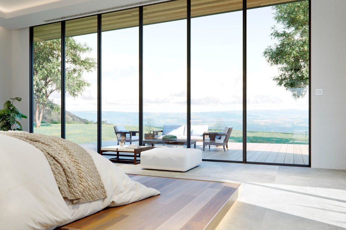 Weather Shield VUE Collection multi-slide patio doors provide an unobstructed connection to the valley landscape from this primary bedroom.