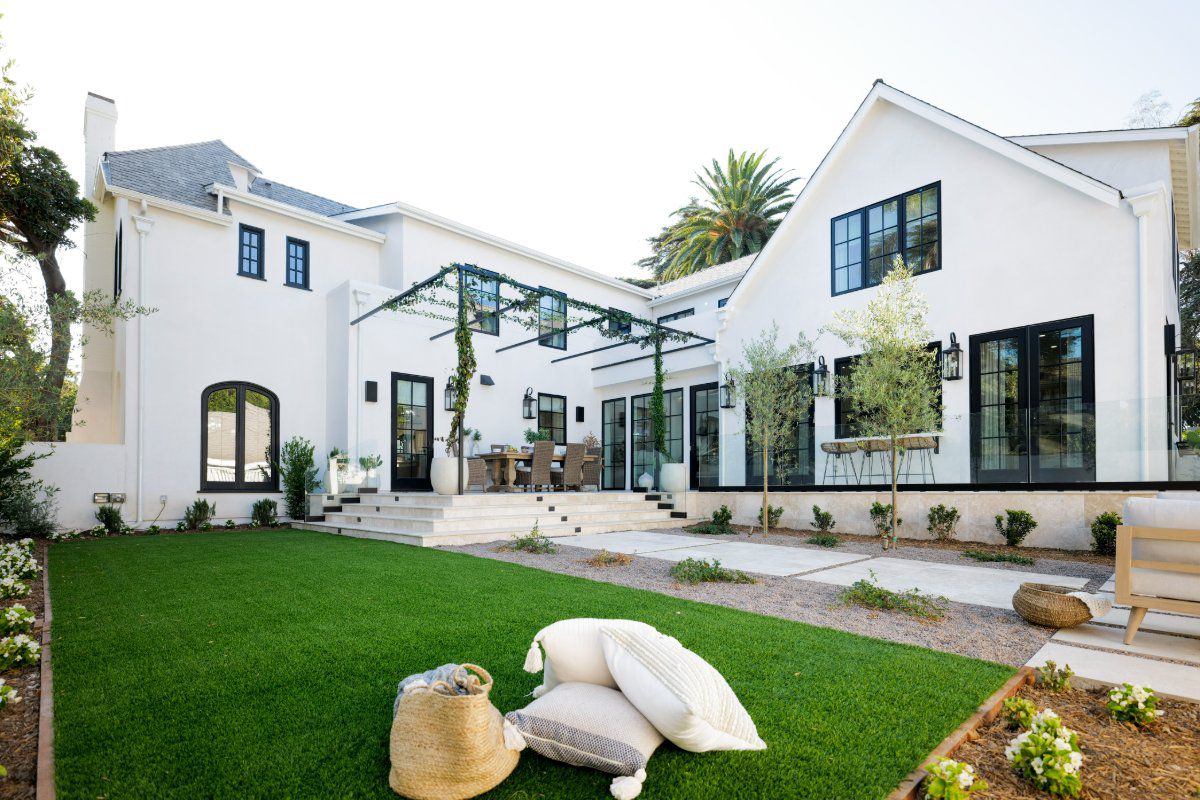 Weather Shield Premium Series aluminum-clad wood windows, a servery window, and hinged patio doors connect indoor and outdoor living spaces.