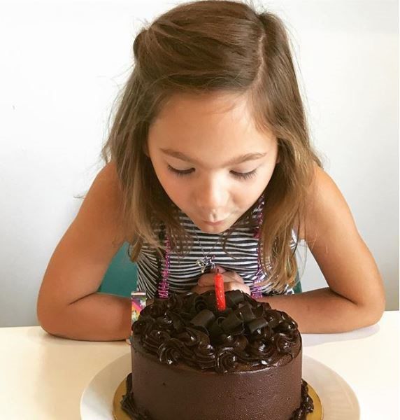 Girl Blowing a Candle