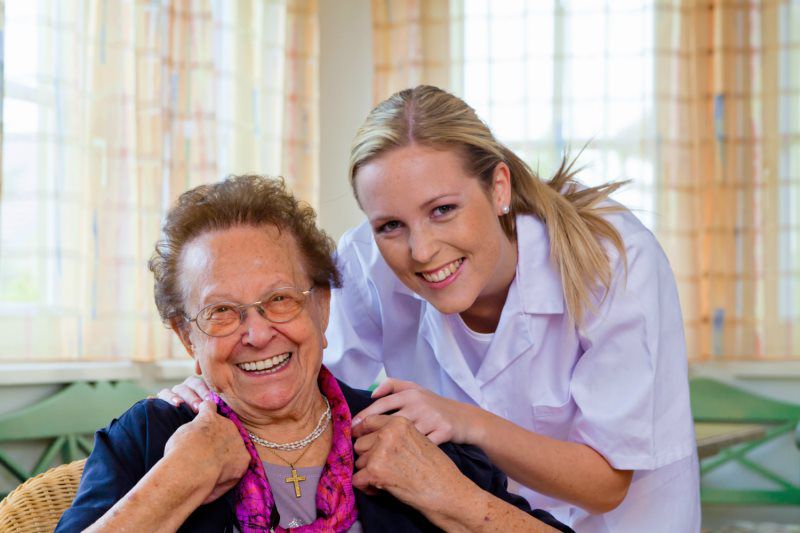 nurse taking care of an aged woman