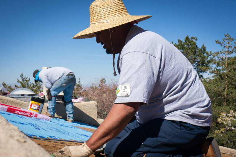 man fixing roof