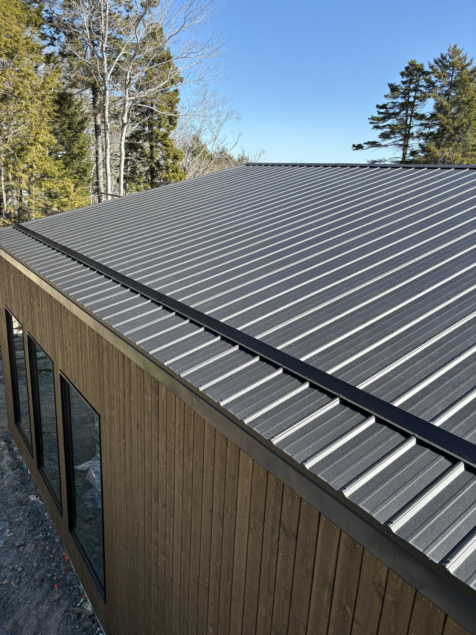 Modern hilltop home with black metal roof
