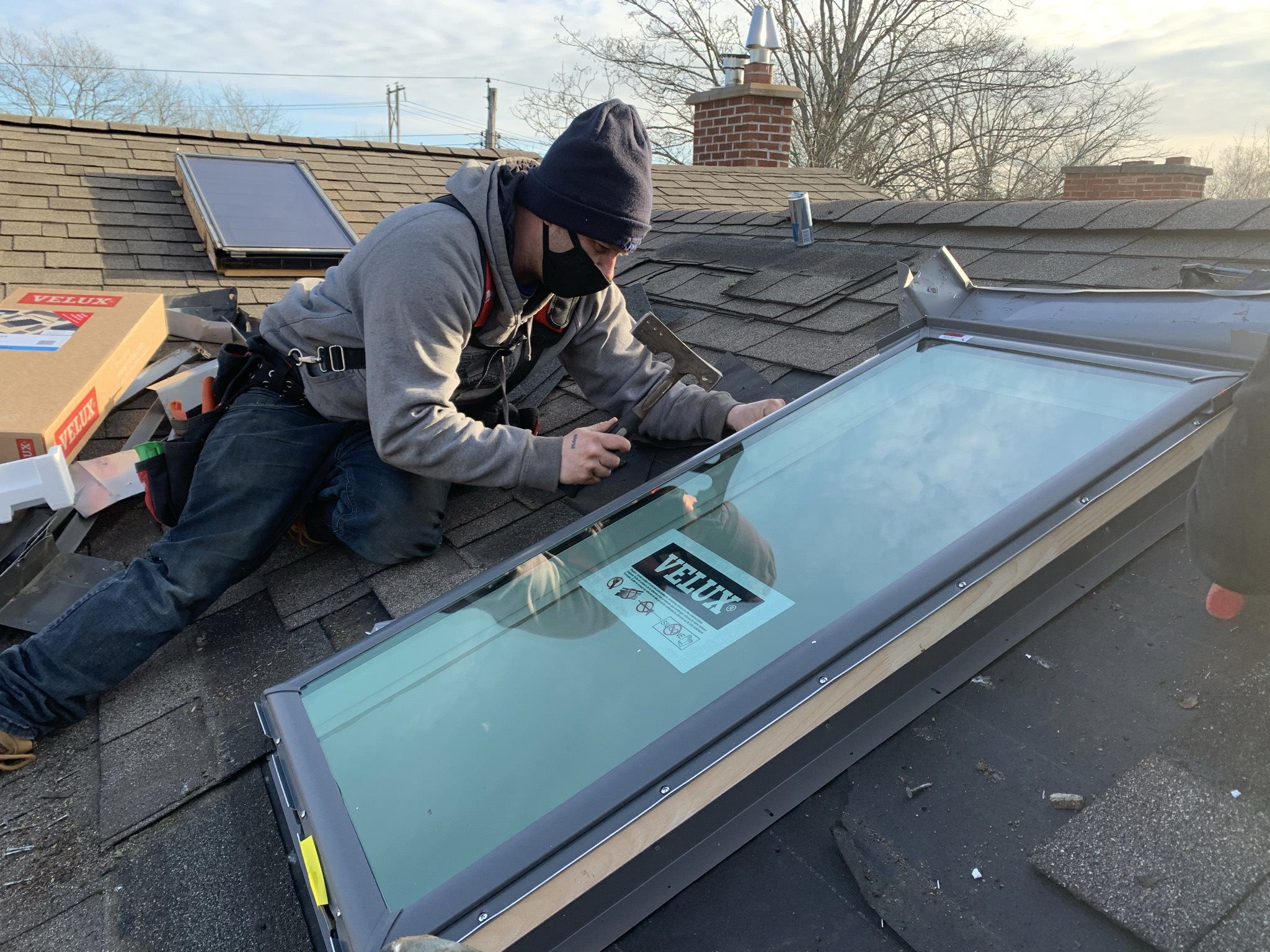 Man installing a Velux skylight on a rooftop