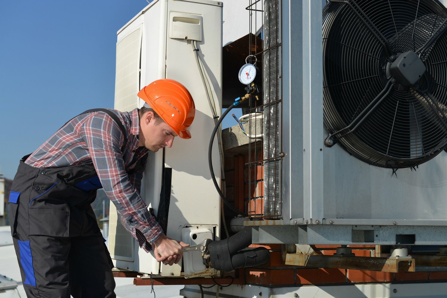 tech fixing an air conditioner 