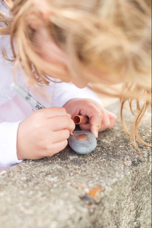 kid writing on the stone