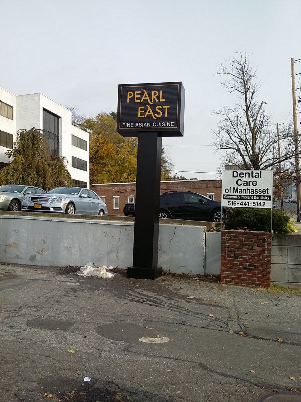 A towering double pylon sign with LED-lit panels showcasing multiple tenant logos, located at a busy commercial plaza.
 The double pylon sign is an impressive and functional signage solution for multi-tenant properties or businesses in high-traffic a