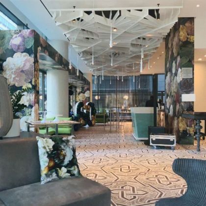 Modern luxury wedding venue lobby with bold floral wallpaper, designer furniture, and artistic ceiling decor in Philadelphia