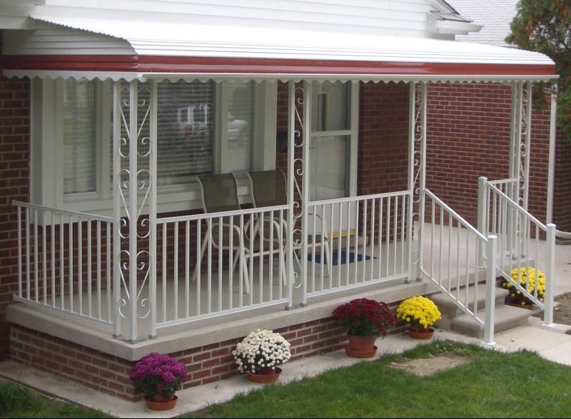 A cozy home with a classic patio awning installed above the backdoor entrance. This residential awning in neutral tones adds elegance to the house while providing shaded protection from the sun. The awning is perfect for patios, backyards, and garden