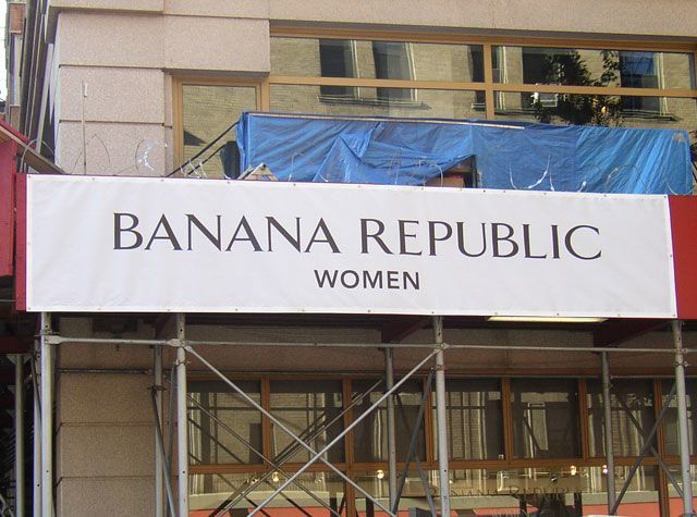 A large commercial building featuring an expansive awning above the entrance, designed for heavy-duty use. This commercial awning canopy provides shade for the entrance area, making it ideal for high-traffic locations like hotels, restaurants, and of