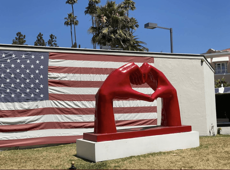Love Los Angeles - Guests love snapping photos at this vibrant heart shaped sculpture, set against American flag mural in the heart of Hollywood. It's one of the many Insta-worthy stops you'll enjoy on our celebrity sightseeing tour.