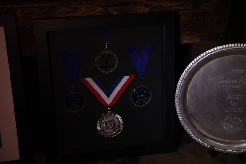 Jason Huguet with medals and certificate