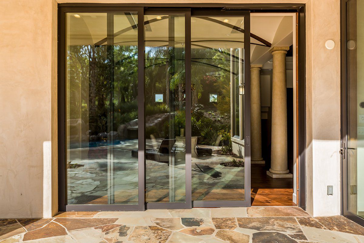 AG Millworks lift and slide doors creating a wide opening to an outdoor living space