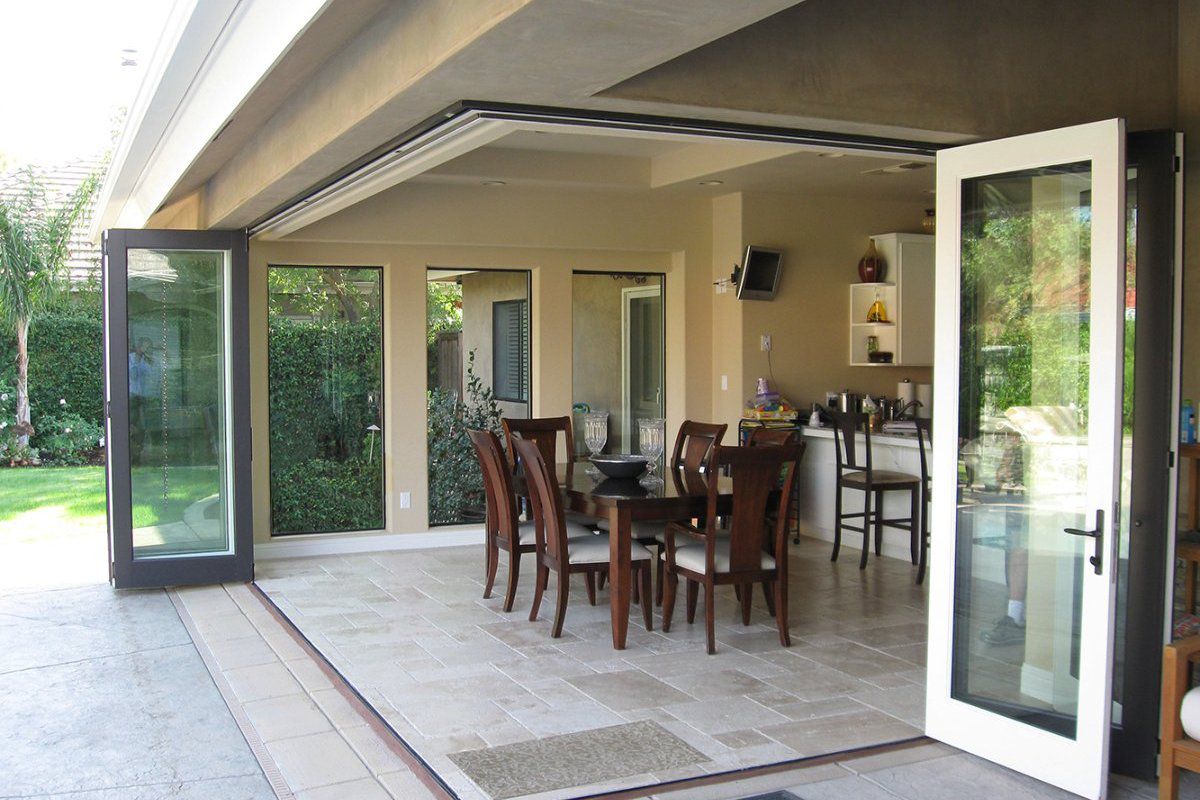 AG Millworks zero-corner bi-fold doors opening a corner of the home to an outdoor living area
