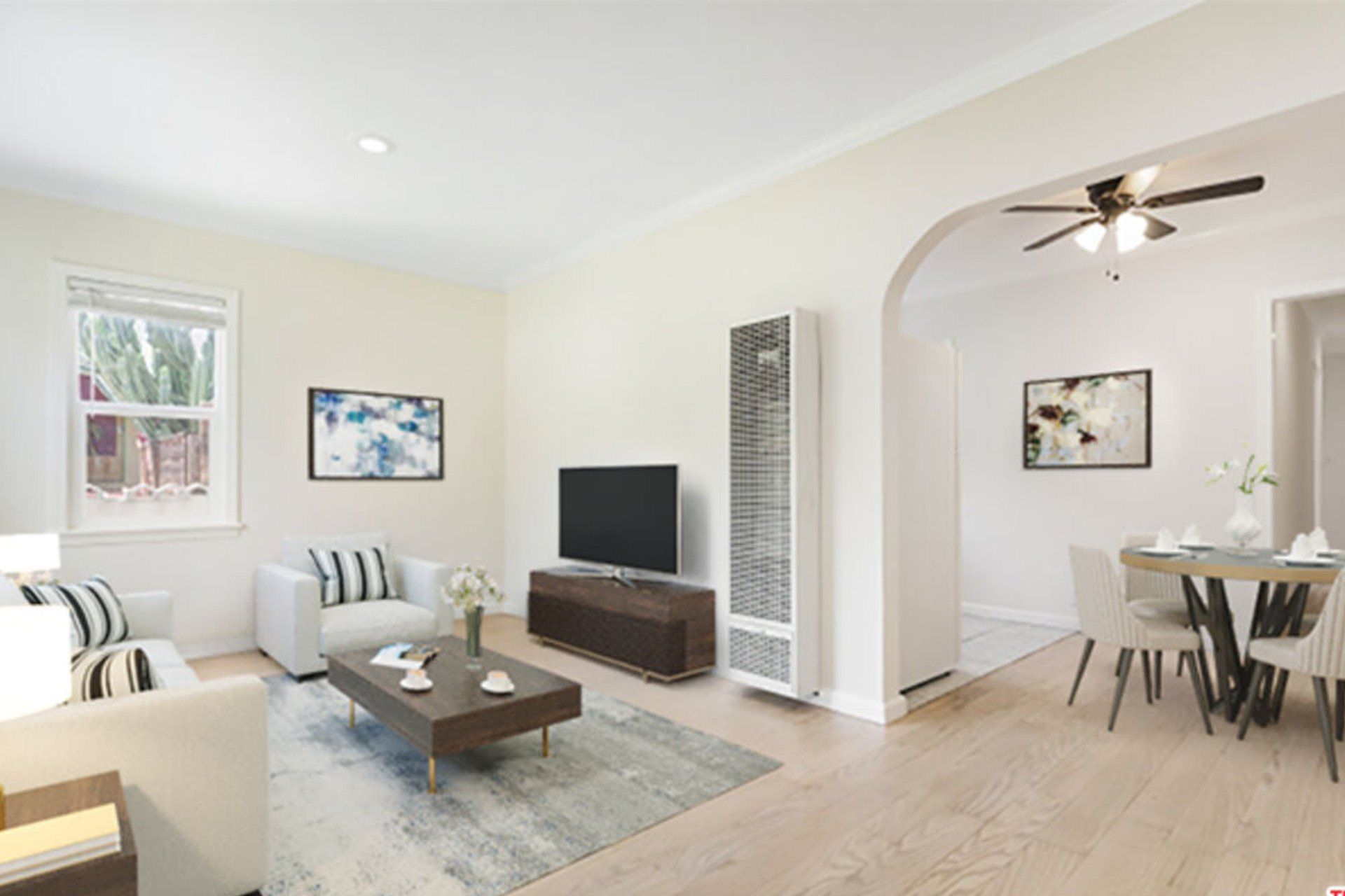 Spacious open-concept living and dining area featuring hardwood floors, recessed lighting, modern furnishings, large windows, and abundant natural light.